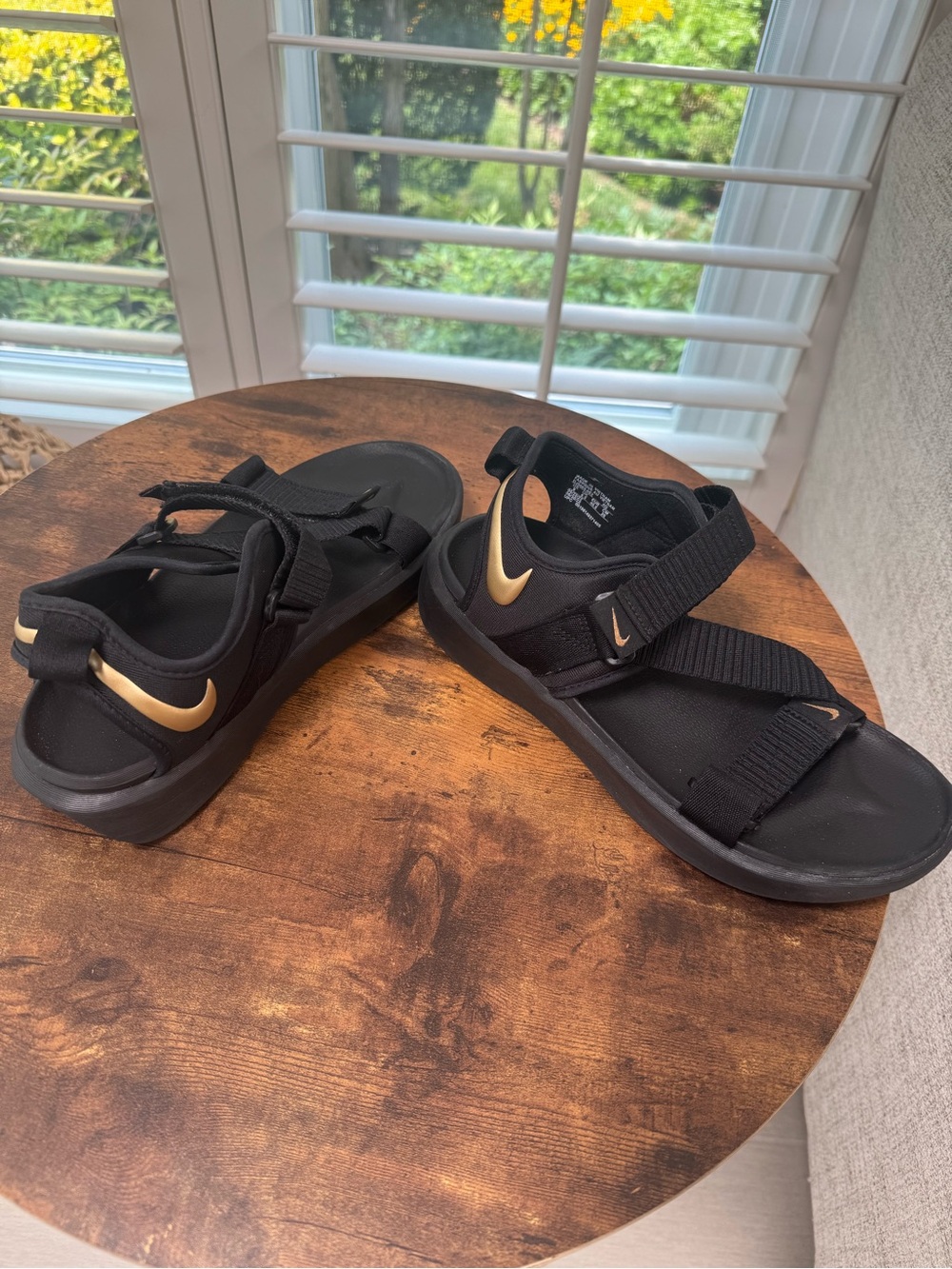 Nike Black Slide Sandals with Gold Swoosh Accent